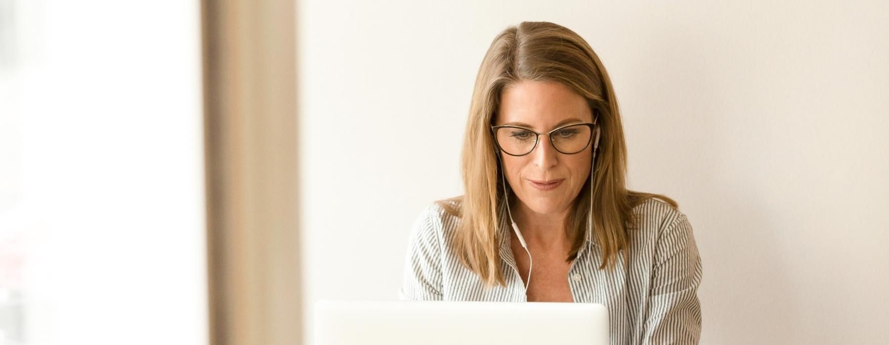 a person sitting at a desk with a laptop