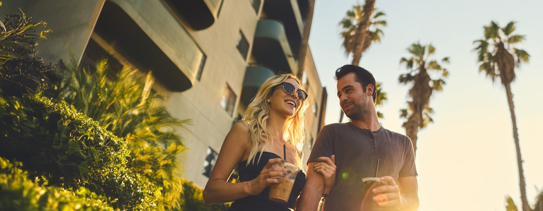 a man and woman holding drinks