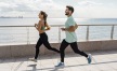 a couple running near the water